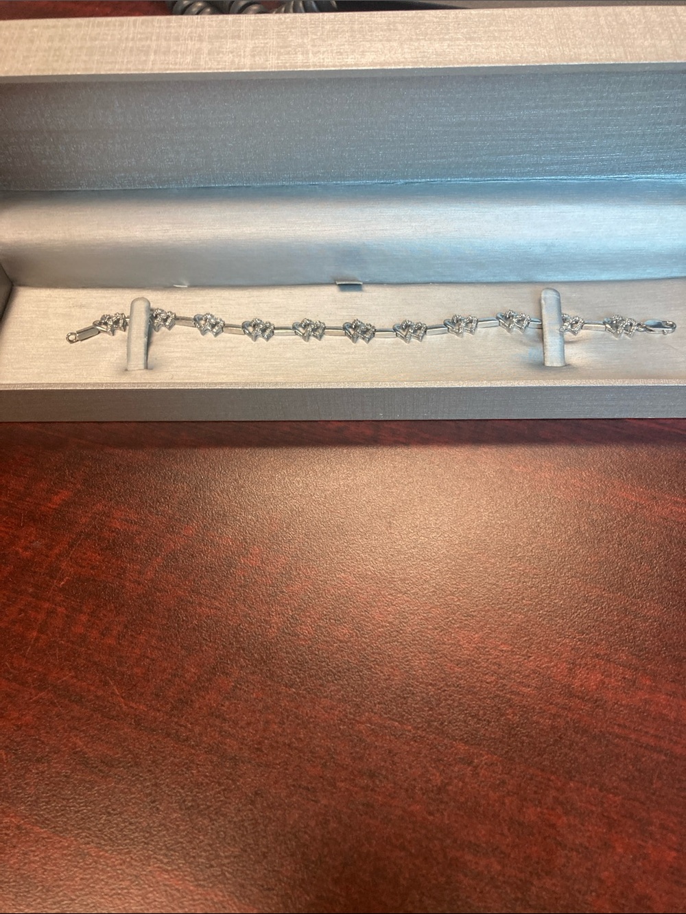 Silver Heart Tennis bracelet 7” with encrusted diamonds. Bracelet has 11 hearts.